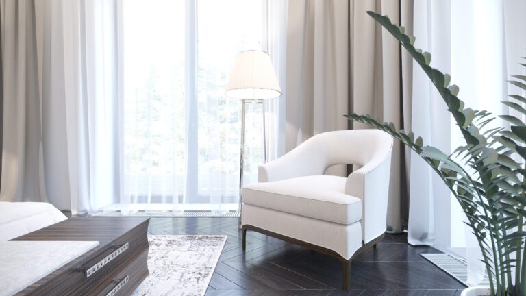 Спальня с паркетом графитового оттенка и белым креслом