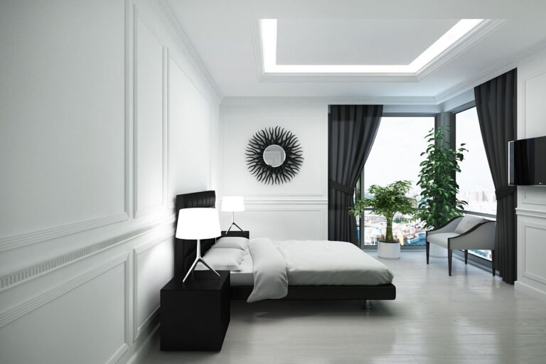 Черная мебель в дизайне просторной белой спальни
