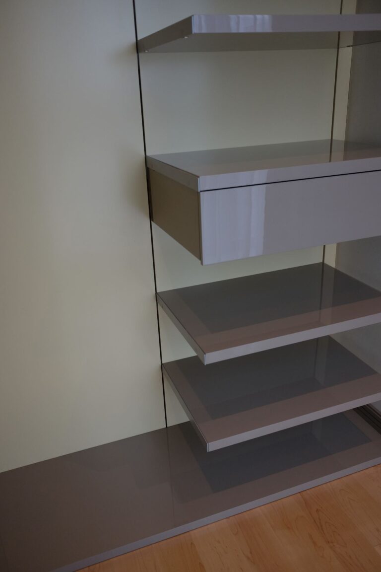 Белая стеновая панель с глянцевыми полками и ящиком цвета какао