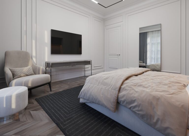 Дизайн спальни с бежевым креслом и белым пуфом