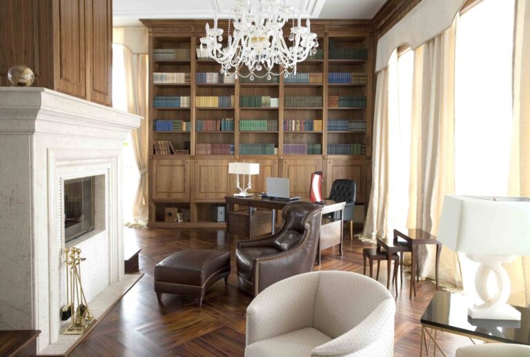Коричневое кожаное кресло в классическом интерьере библиотеки