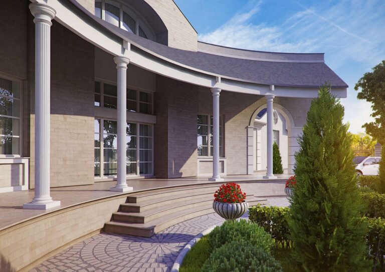 Декоративные растения на участке перед особняком с колоннадой