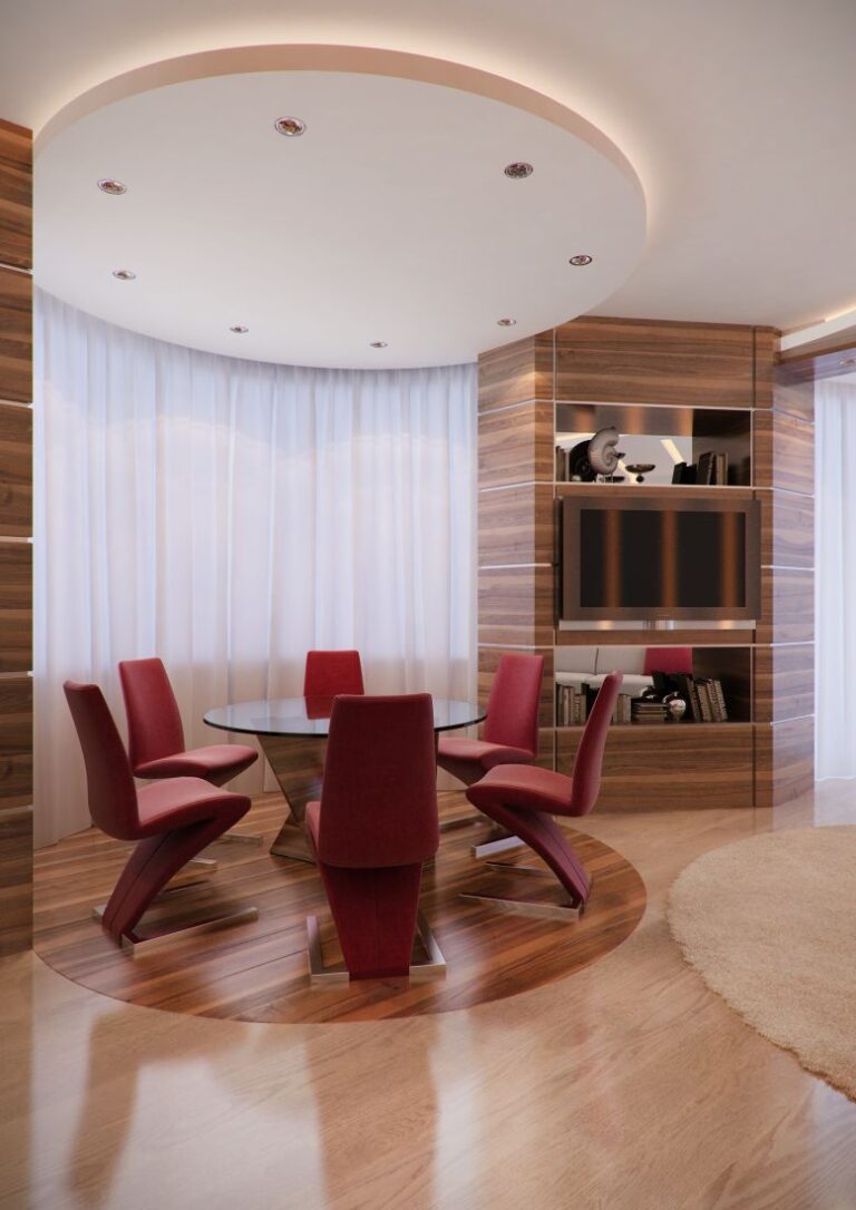 Круглый стеклянный стол с красными стульями в оформлении столовой