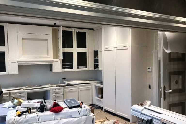 Глухие и застекленные распашные дверки в оформлении белой кухни